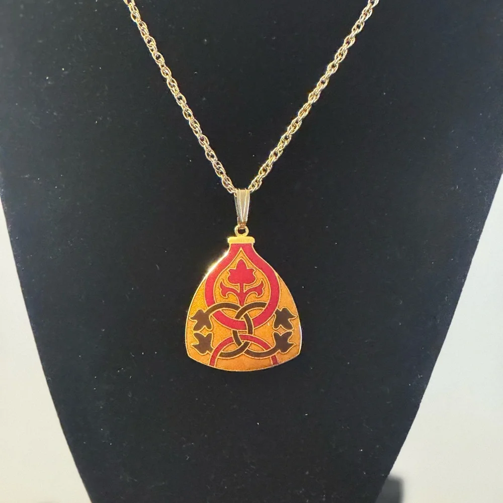 Gold tone signed Celtic knot pendant necklace in red, black and orange enamel